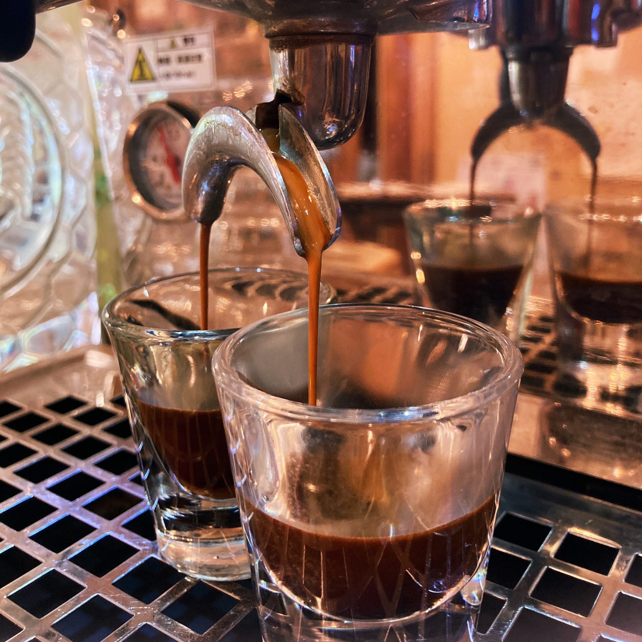Espresso pouring into two glasses at SOMA Café in Nakijin, Okinawa